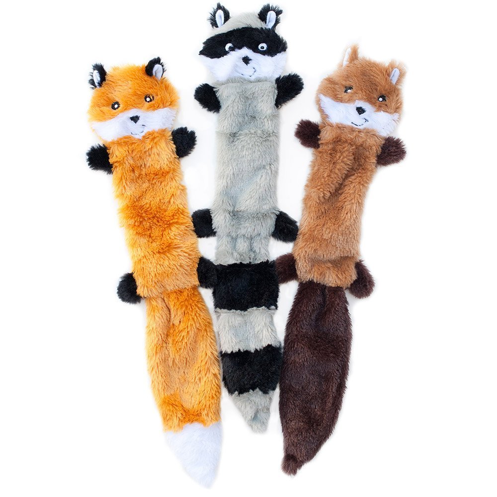 Squeaky dog toy in use — dog playing with plush toy set