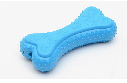Squeaky dog toy in use — dog chewing rubber biscuit toy