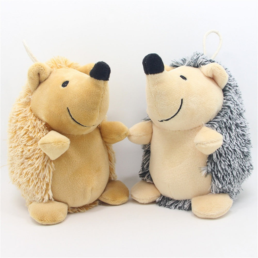 Dog playing with brown plush hedgehog squeaky toy Canada