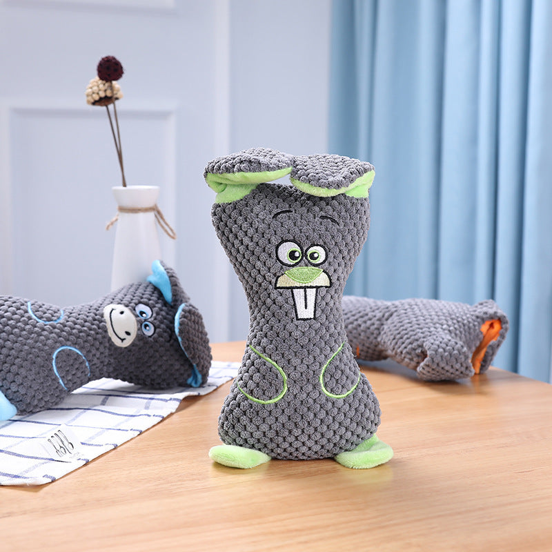 Floppy plush dog toy in use — dog playing with stuffed toy